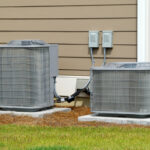 Central air conditioners set up outside house